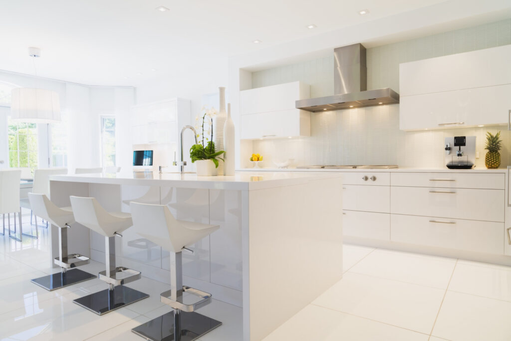 Modern white kitchen with island bench and bar stools